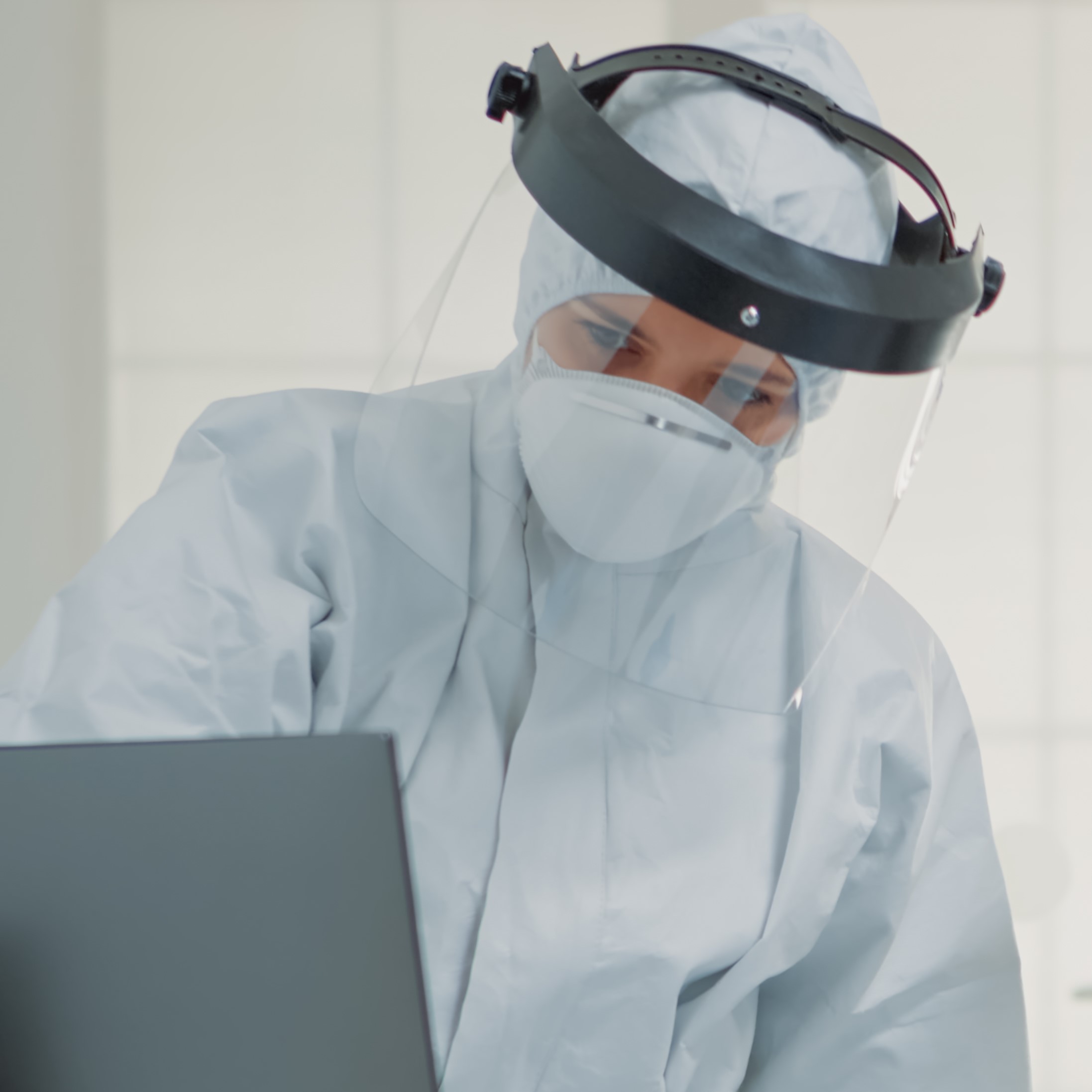 Dentistry team of specialists with ppe suits using computer for modern dental healthcare. Nurse sitting at desk, looking at monitor while dentist analyzing screen during covid pandemic