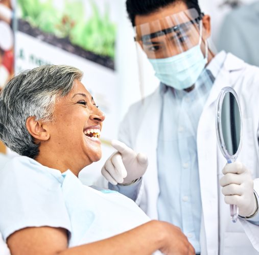 Dental, healthcare or mirror with a dentist and patient consulting in an oral hygiene appointment. Teeth, cleaning and mature woman client at the orthodontist for a medical checkup to prevent decay.